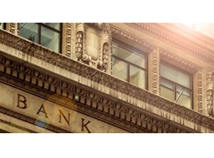 brick building with brass sign that reads bank